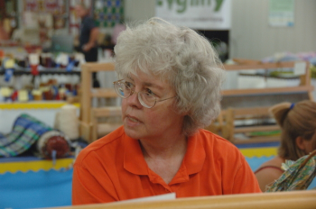 Weaver at rug loom.