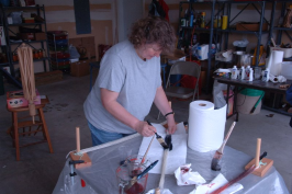 Woman painting yarn with paintbrush