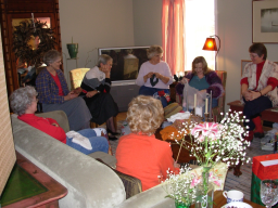 Woman opening present while others wait to see